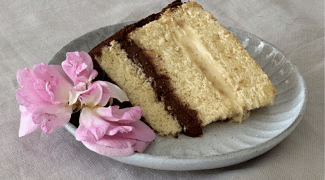 a plate with a slice of cake and a flower