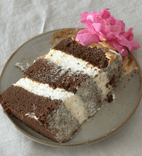 a slice of chocolate cake with caramel and whipped cream