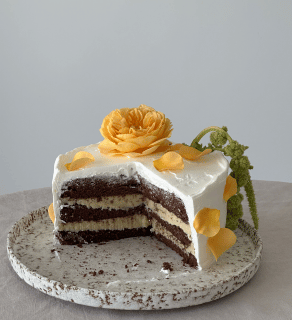 white frosted cake with flowers on top